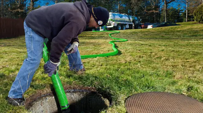 Service technician performing residential septic pumping and drainage maintenance in Myrtle Beach, SC